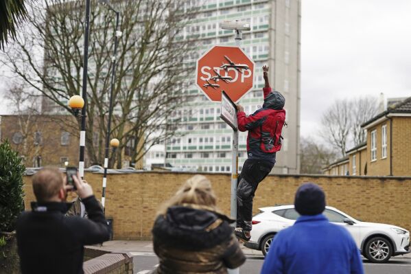 Second suspect arrested in theft of Banksy stop sign artwork featuring military drones