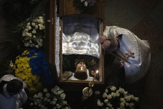 Hundreds gather in Ukraine’s capital to honor renowned poet who was also a soldier killed in action