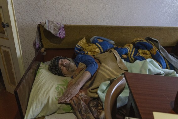 Under bombing in eastern Ukraine and disabled by illness, an unknown painter awaits his fate