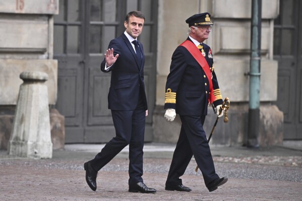 France’s president gets a ceremonial welcome as he starts a 2-day state visit to Sweden