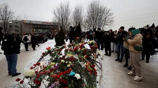 Alexei Navalny’s parents bury their son as thousands chant his name