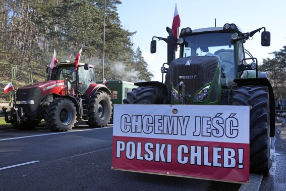 With unsold grain piled high, a Polish farmer faces an uncertain future as war in Ukraine grinds on