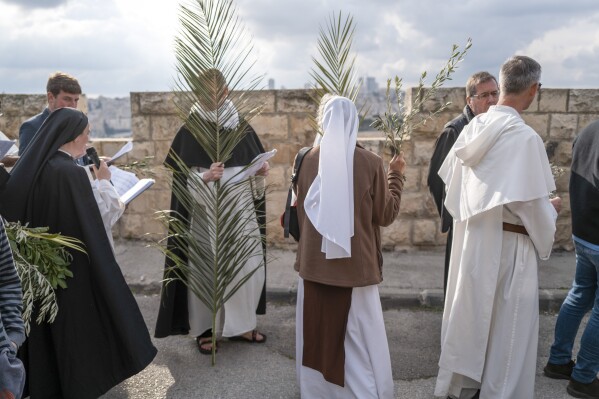 Thousands of faithful attend Palm Sunday celebrations in Jerusalem against a backdrop of war