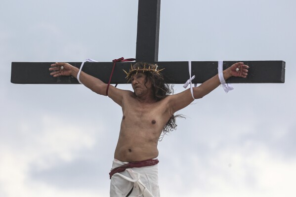 A Filipino villager is nailed to a cross for the 35th time on Good Friday to pray for world peace