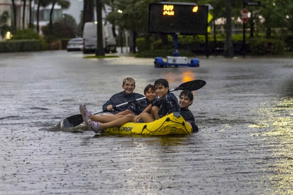 Tropical rainstorms in South Florida lead to flight delays and streets jammed with stalled cars