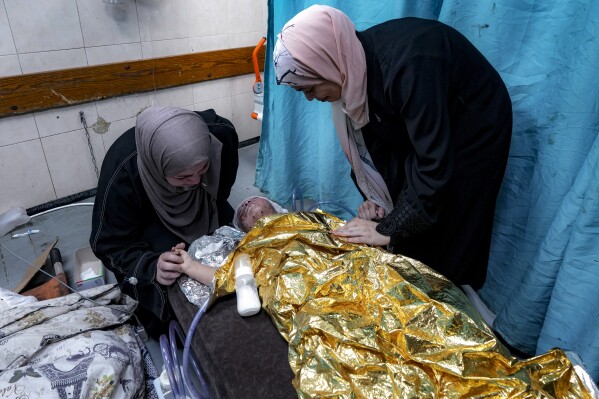 Wounded in a strike that killed her family, a 2-year-old joins Gaza’s ranks of thousands of orphans