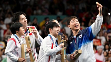 EXPLAINED: Why North Korea’s Olympic silver medalists may face punishment for smiling during a selfie with ‘number one enemy’ – South Korean counterparts