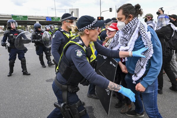 Anti-war protesters in Australia clash with police outside a weapons convention